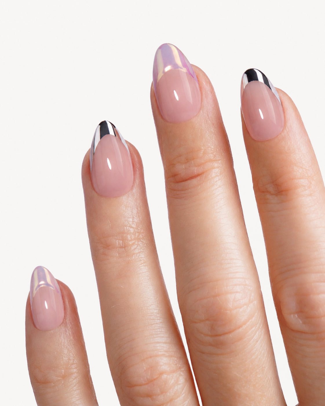 Close-up of Discours almond press-on nails featuring nude base color and sleek metallic French tip design for a minimalist elegant manicure