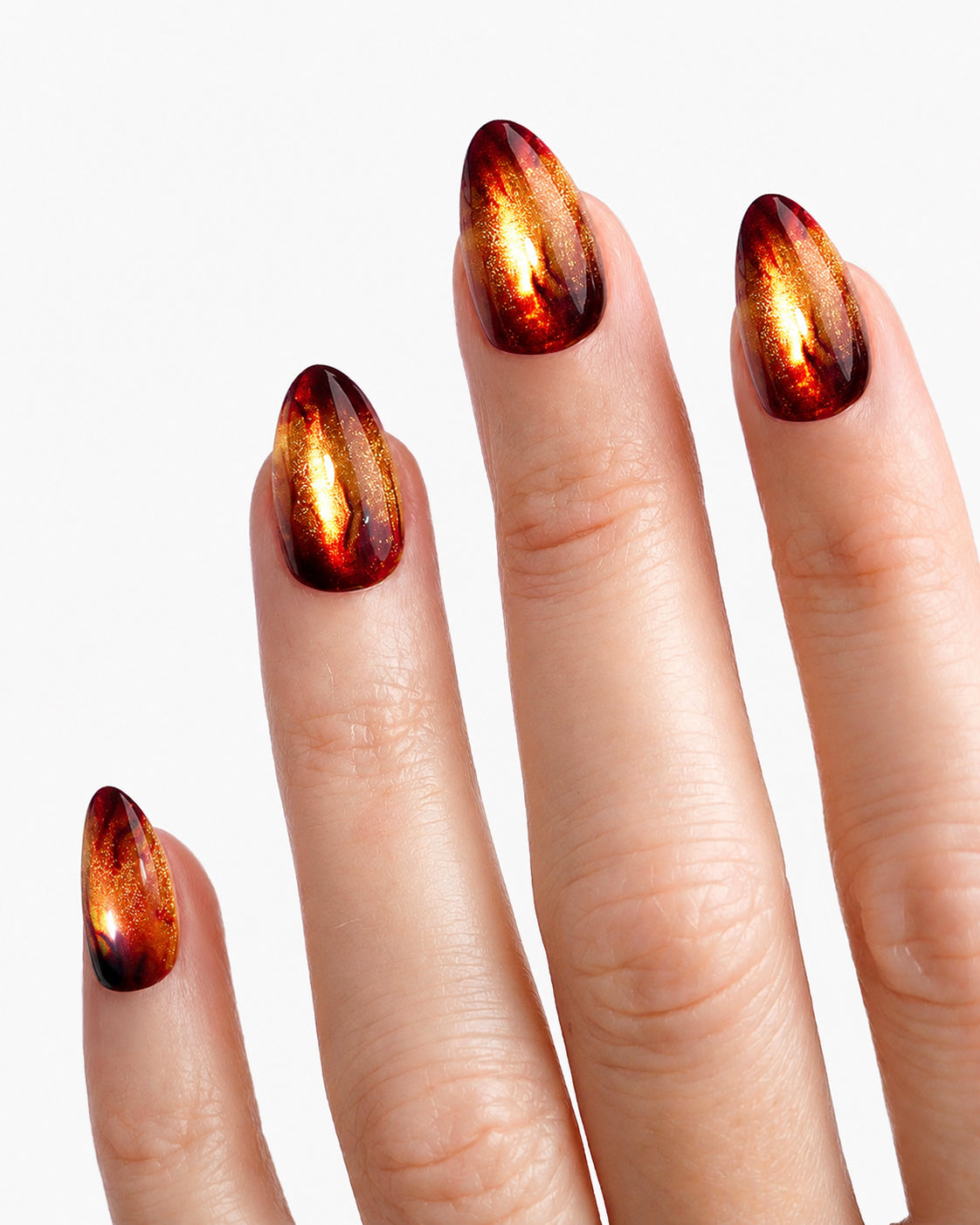 Close-up of VSALON Amber Whisper press-on nails showcasing the golden brown cat-eye effect and flowing flame-inspired nail art.