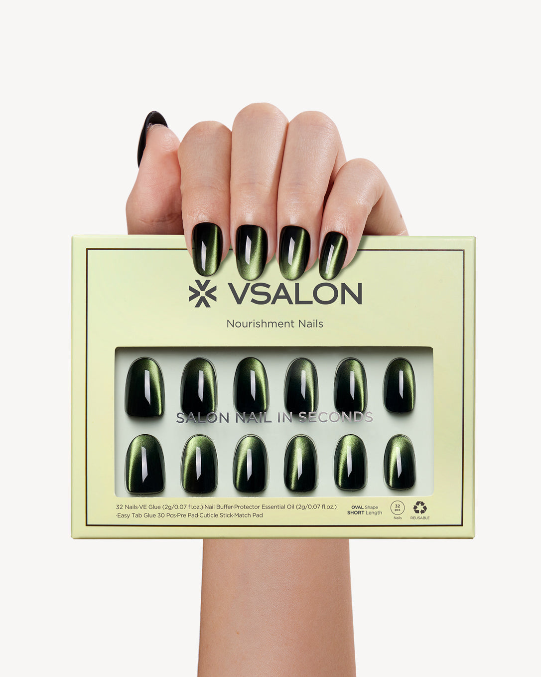 Hand holding VSALON Velvet Moss press-on nails with a sophisticated emerald green cat-eye manicure.