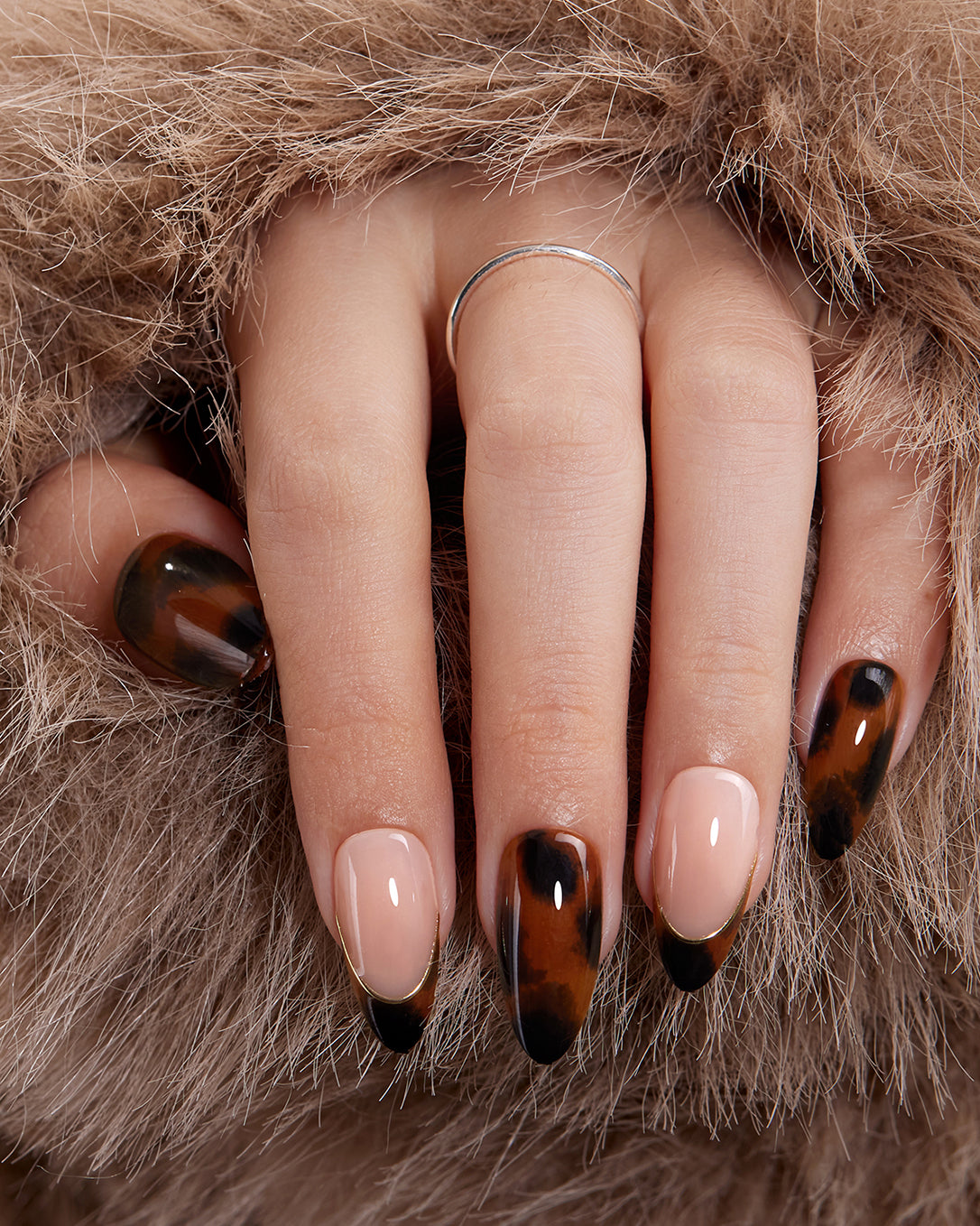 Model wearing VSALON Leopard Luxe press-on nails featuring a sophisticated leopard print manicure for fall and winter looks.