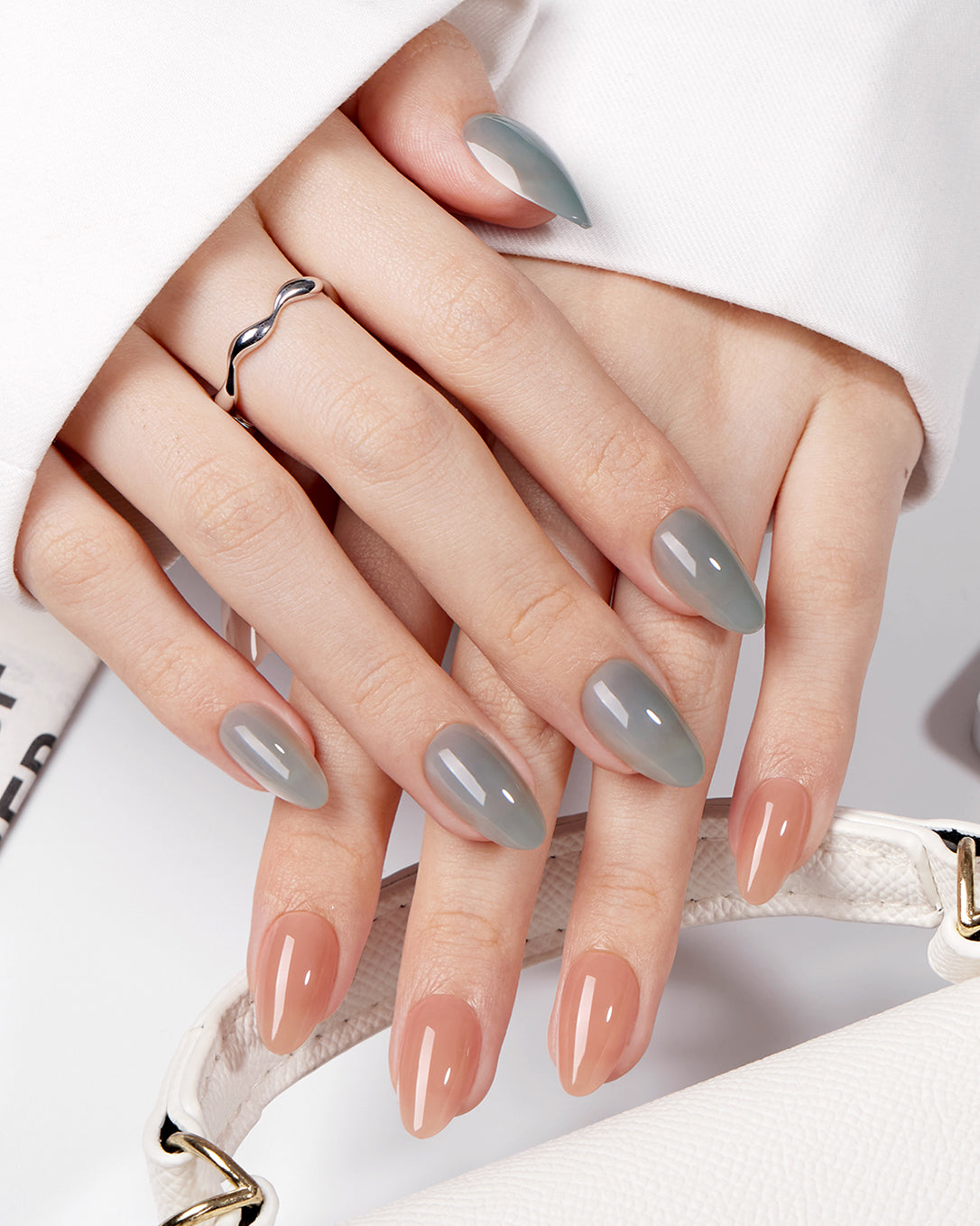 Charming Blossoms two tone almond press-on nails creating a modern gray and nude everyday manicure look