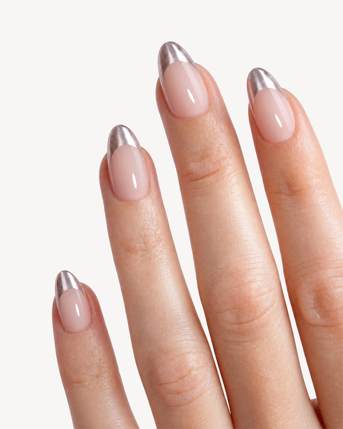Starlit Chrome metallic French tip almond press-on nails with glossy nude base on natural nails