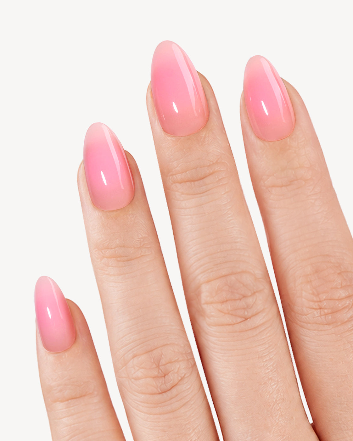 VSALON Timeless Ombre short almond soft gel press-on nails worn on hand with a glossy light-to-rose pink gradient