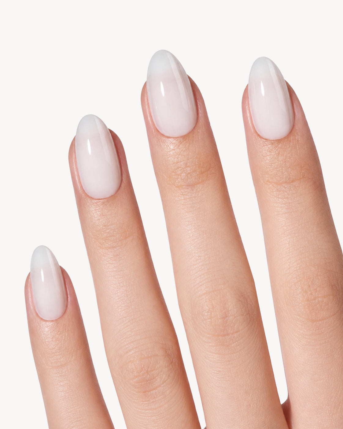 VSALON Pearl Glow short almond soft gel press-on nails worn on hand with a glossy pearlescent white finish