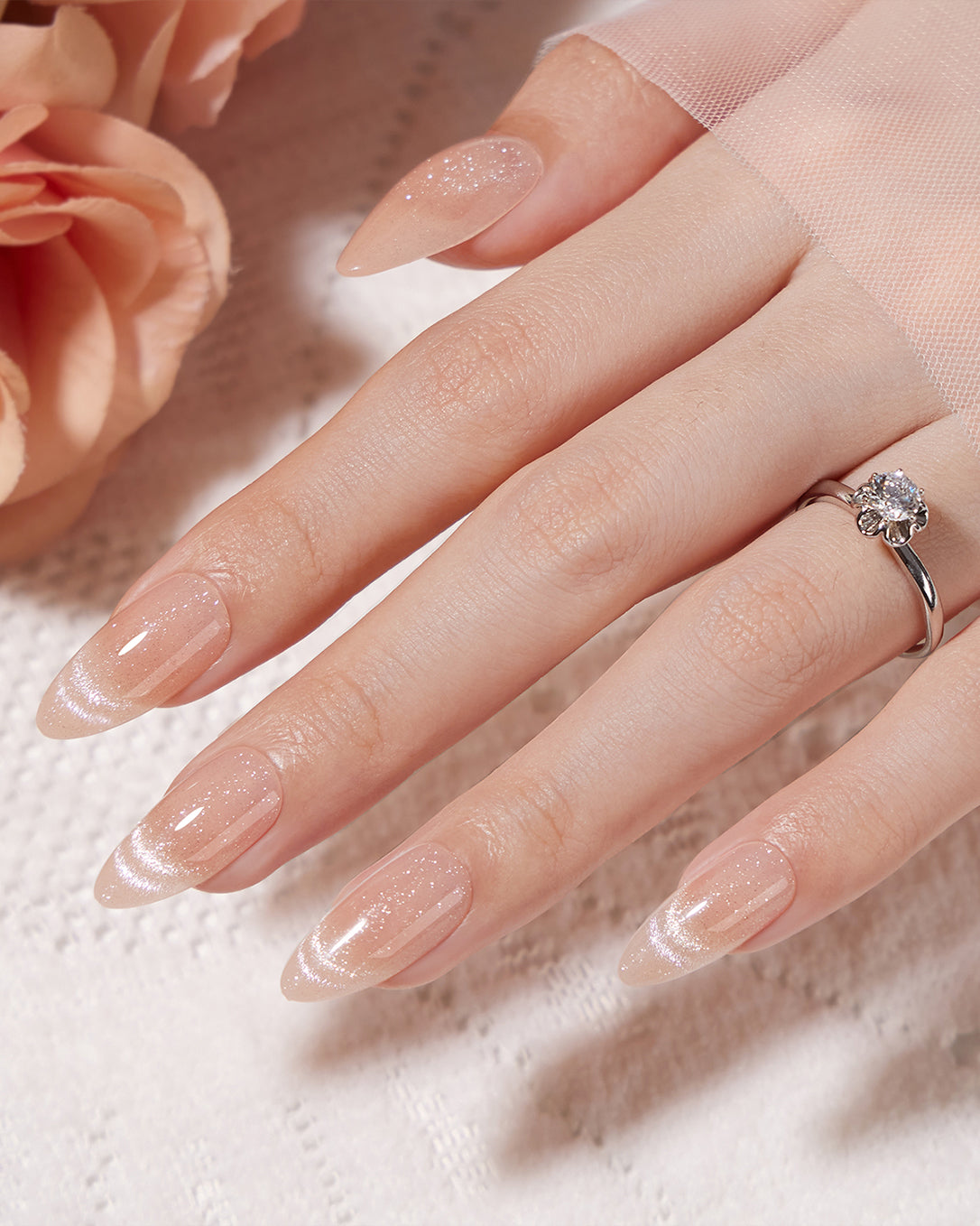 Mummy soft pink shimmer almond press-on nails creating an elegant natural and feminine manicure look