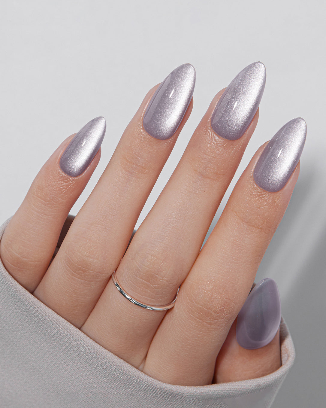 Model wearing VSALON Lilac Aura press-on nails featuring an elegant lavender shimmer manicure for a soft feminine look.