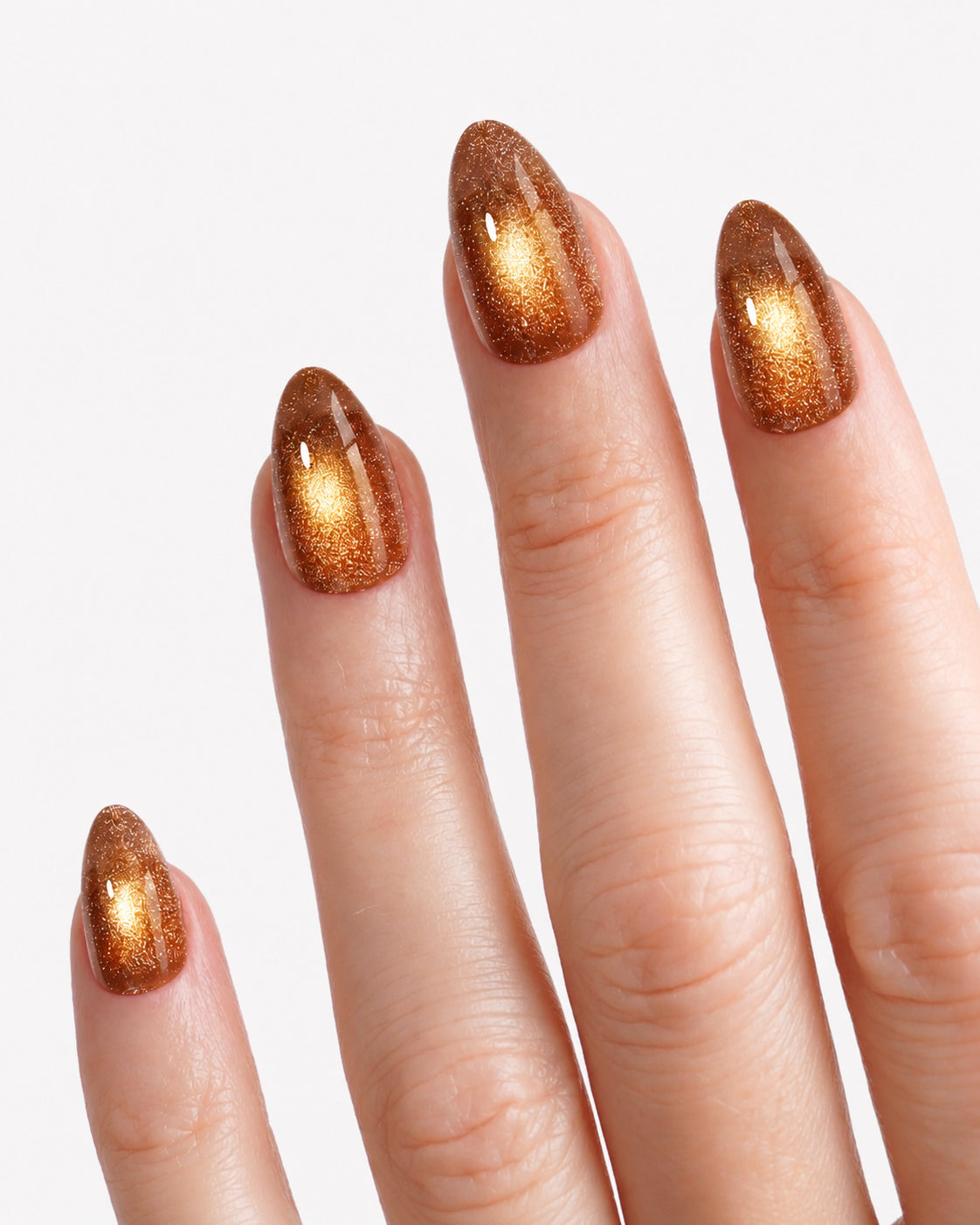 Close-up of VSALON Truffle Halo press-on nails showcasing the wide-light magnetic cat-eye effect and golden velvet-like shimmer.