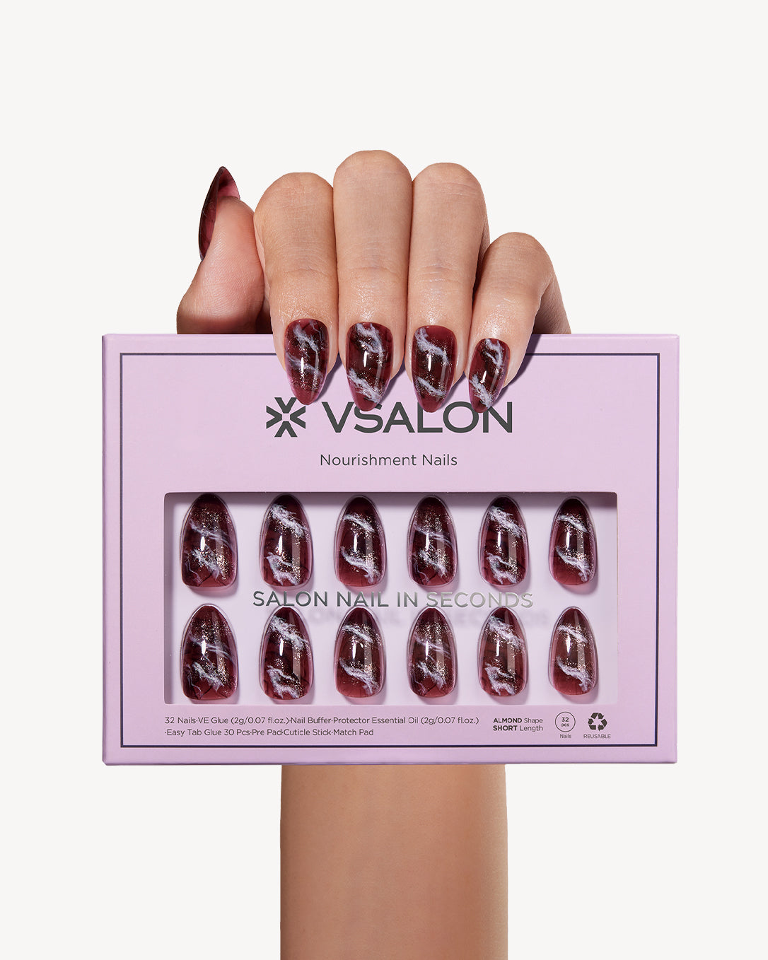 Hand holding VSALON Smoky Marble press-on nails with a chic smoky brown marble manicure and subtle sparkling details.