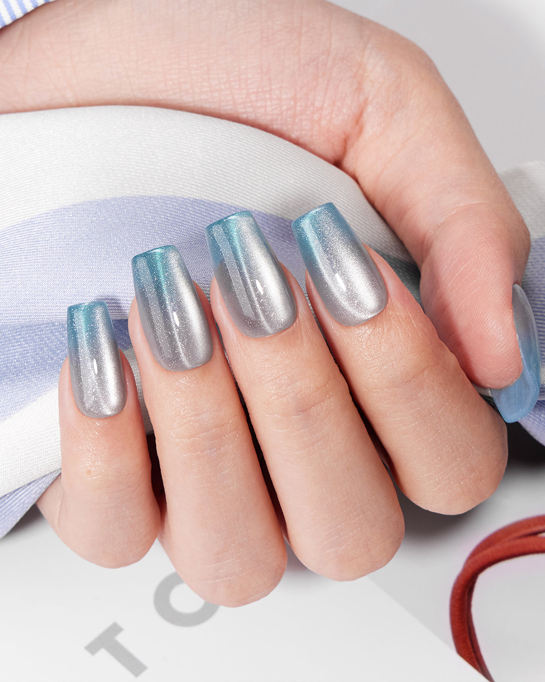 Model wearing VSALON Crystal Tide press-on nails with an elegant crystal-inspired cat-eye manicure.
