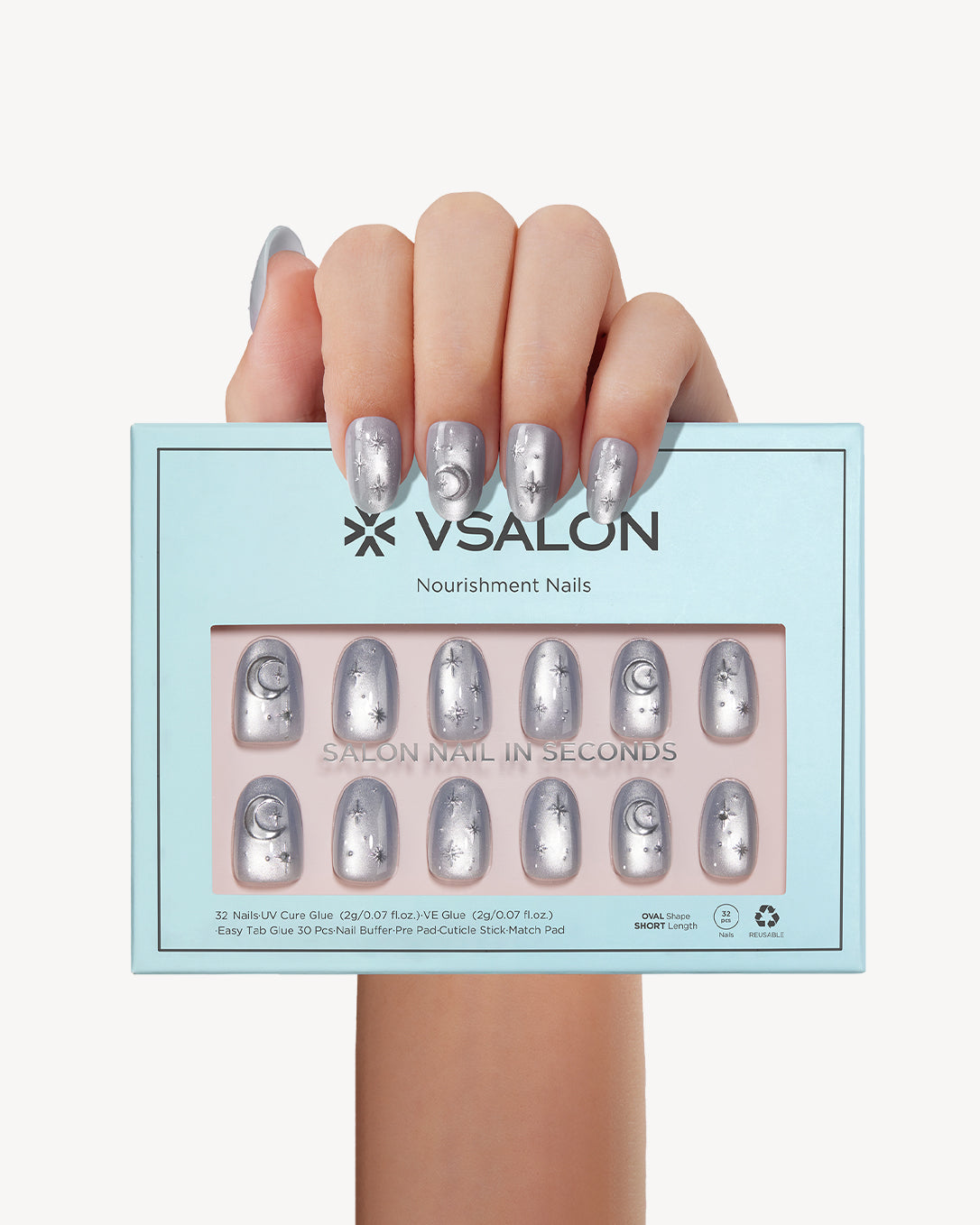 Hand holding VSALON Moonlight Sonata press-on nails with a cool gray-blue cat-eye manicure and sparkling silver accents.
