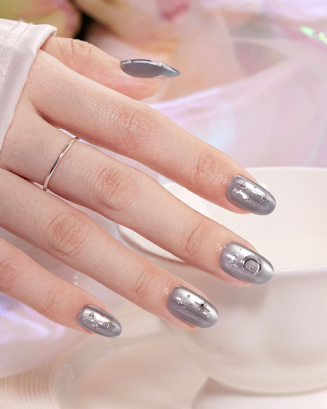 Model wearing VSALON Moonlight Sonata press-on nails featuring a frosty gray-blue cat-eye manicure with elegant celestial details.