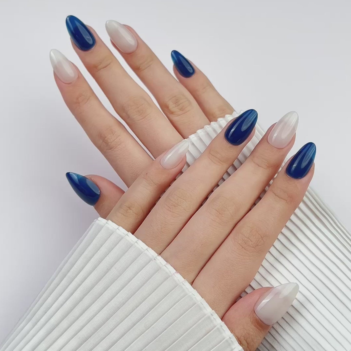 Load video: VSALON Dual Glam Nails Sky Cloud Blue Solid Color Short Almond Press On Nails - Model showing nails with both hands – displaying nail design and manicure style