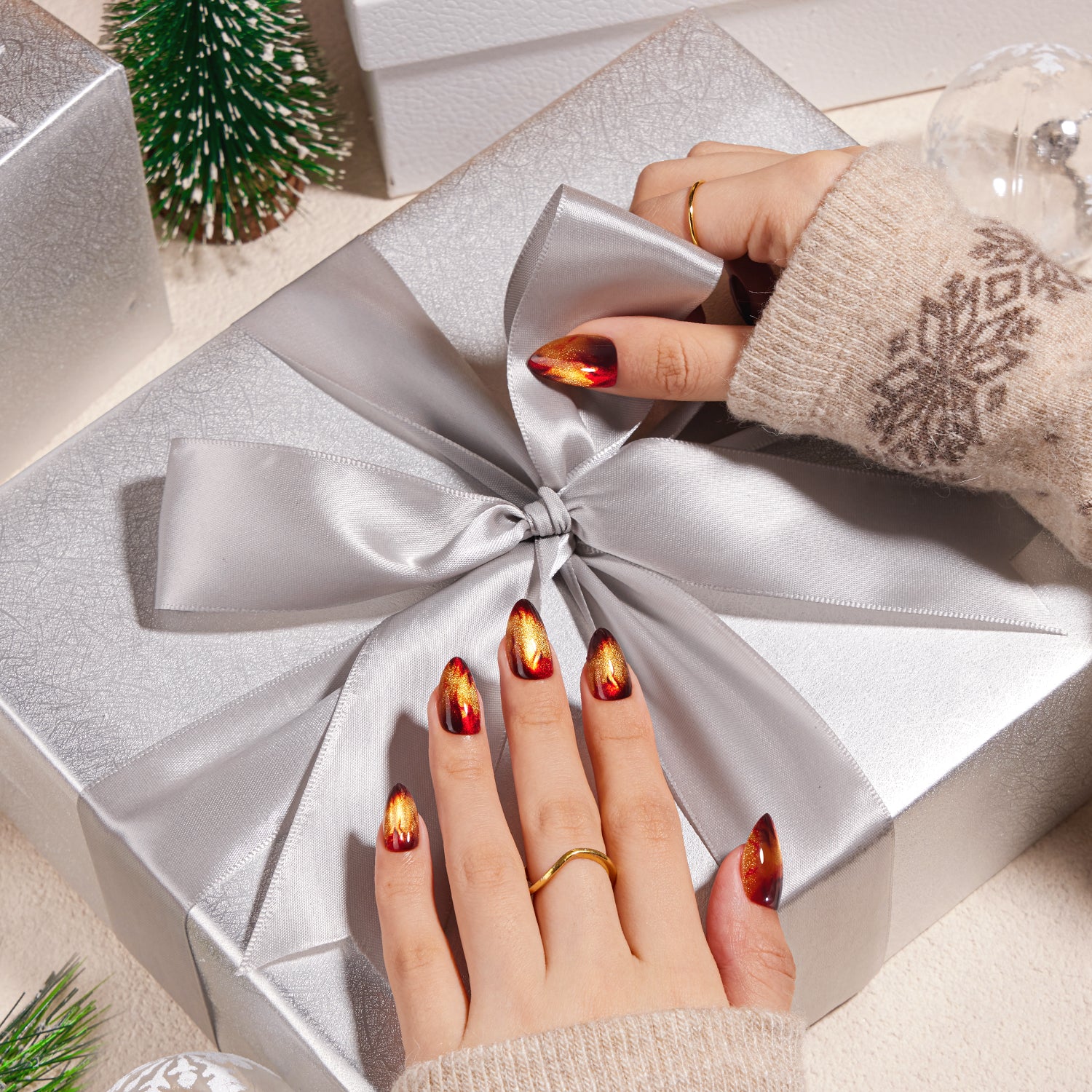 VSALON Nourishment Amber Whisper Golden Brown Cat Eye Flame Medium Almond Press On Nails - Model holding VSALON press on nails box diagonally with both hands – highlighting packaging and nail set presentation