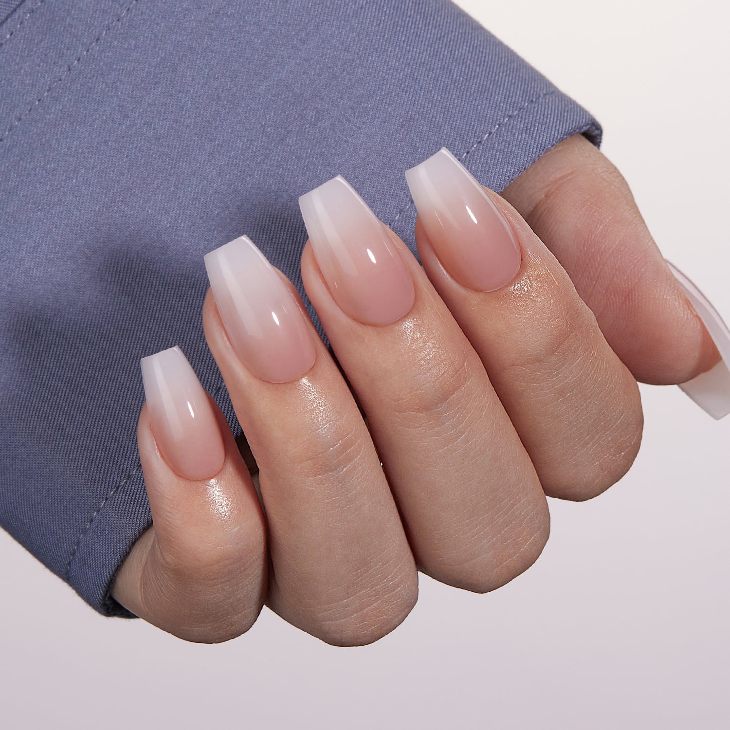 VSALON Dual Glam Nails Belle De Jour French Tips Short Coffin Press On Nails - Close-up of model's hand bending fingers to hold VSALON press on nails – highlighting nail design and color details