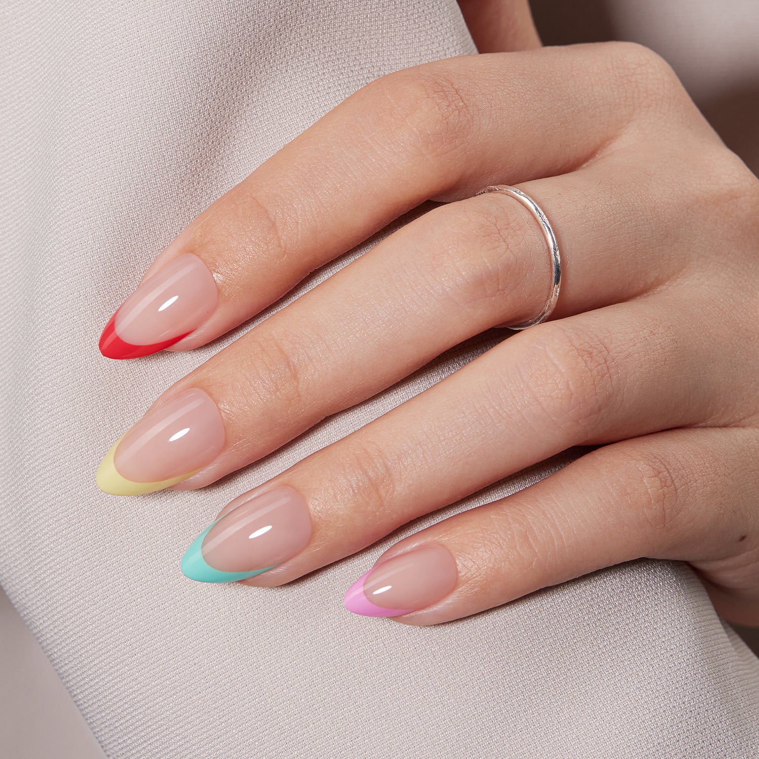 VSALON Nourishment Color Pop French Tips Short Almond Press On Nails - model's hand resting on elbow – showcasing nail style and elegant manicure