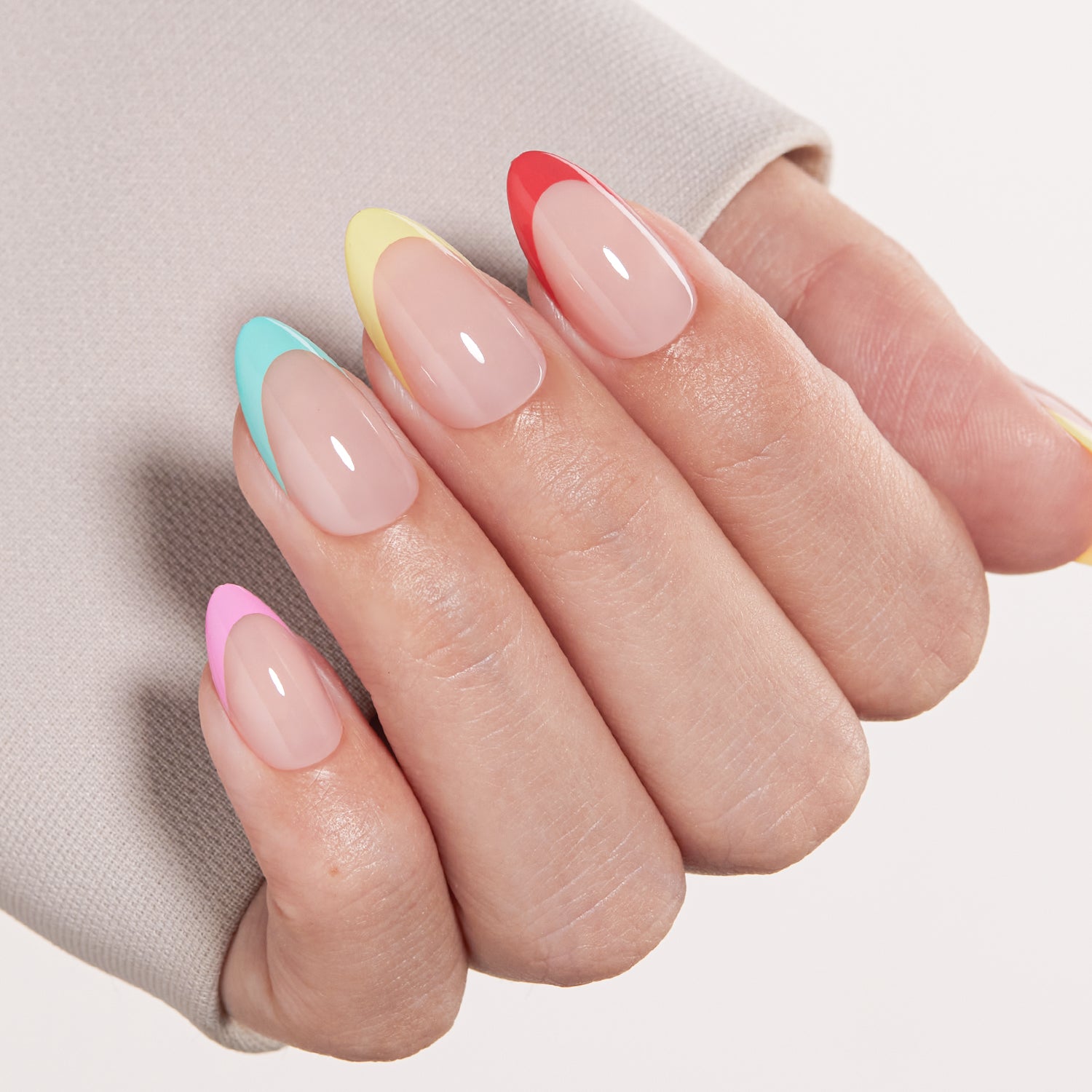 VSALON Nourishment Color Pop French Tips Short Almond Press On Nails - Close-up of model's hand bending fingers to hold VSALON press on nails – highlighting nail design and color details