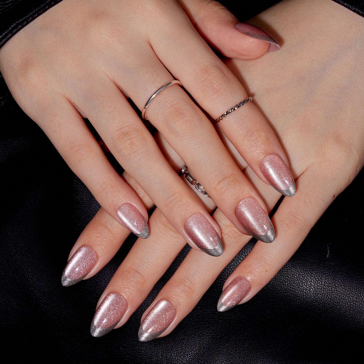 VSALON Nourishment First Dance Pink Metallic French Tips  Short Almond Press On Nails - Model's hands with fingers crossed showing VSALON press on nails – highlighting nail design and style