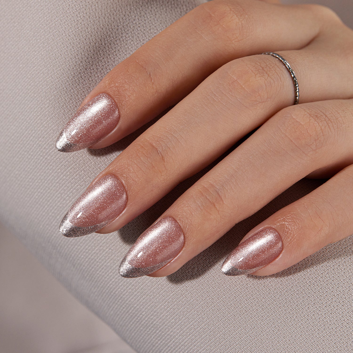 VSALON Nourishment First Dance Pink Metallic French Tips  Short Almond Press On Nails - model's hand resting on elbow – showcasing nail style and elegant manicure