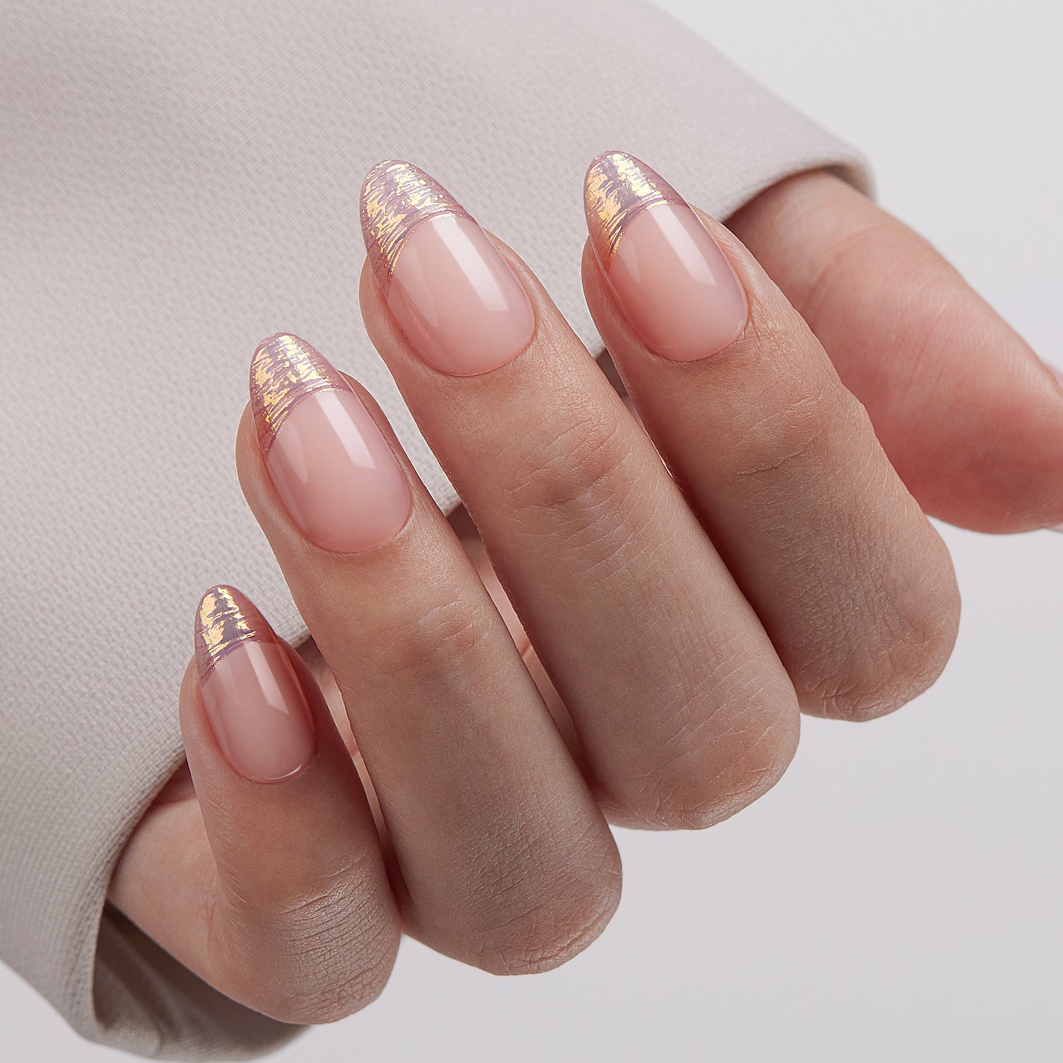 VSALON UV Cure Nails Golden Dream Nude Pink Ombre French Tips Short Almond Press On Nails - Close-up of model's hand bending fingers to hold VSALON press on nails – highlighting nail design and color details