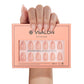 VSALON UV Cure Nails Golden Dream Nude Pink Ombre French Tips Short Almond Press On Nails - model's hand holding the top of the box – displaying nail design and product packaging