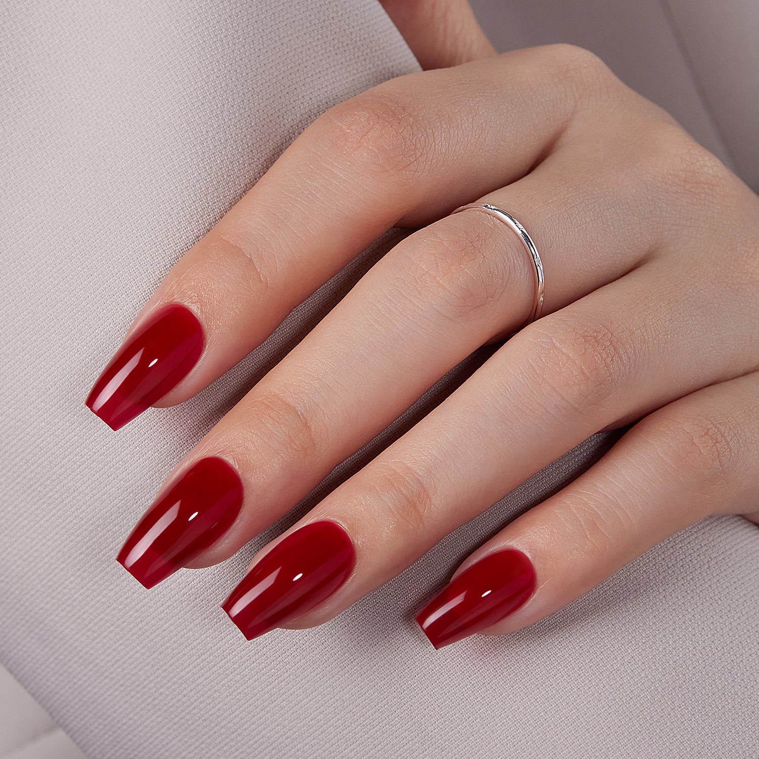 VSALON Dual Glam Nails Happy Glow Red Solid Color Short Coffin Press On Nails - model's hand resting on elbow – showcasing nail style and elegant manicure