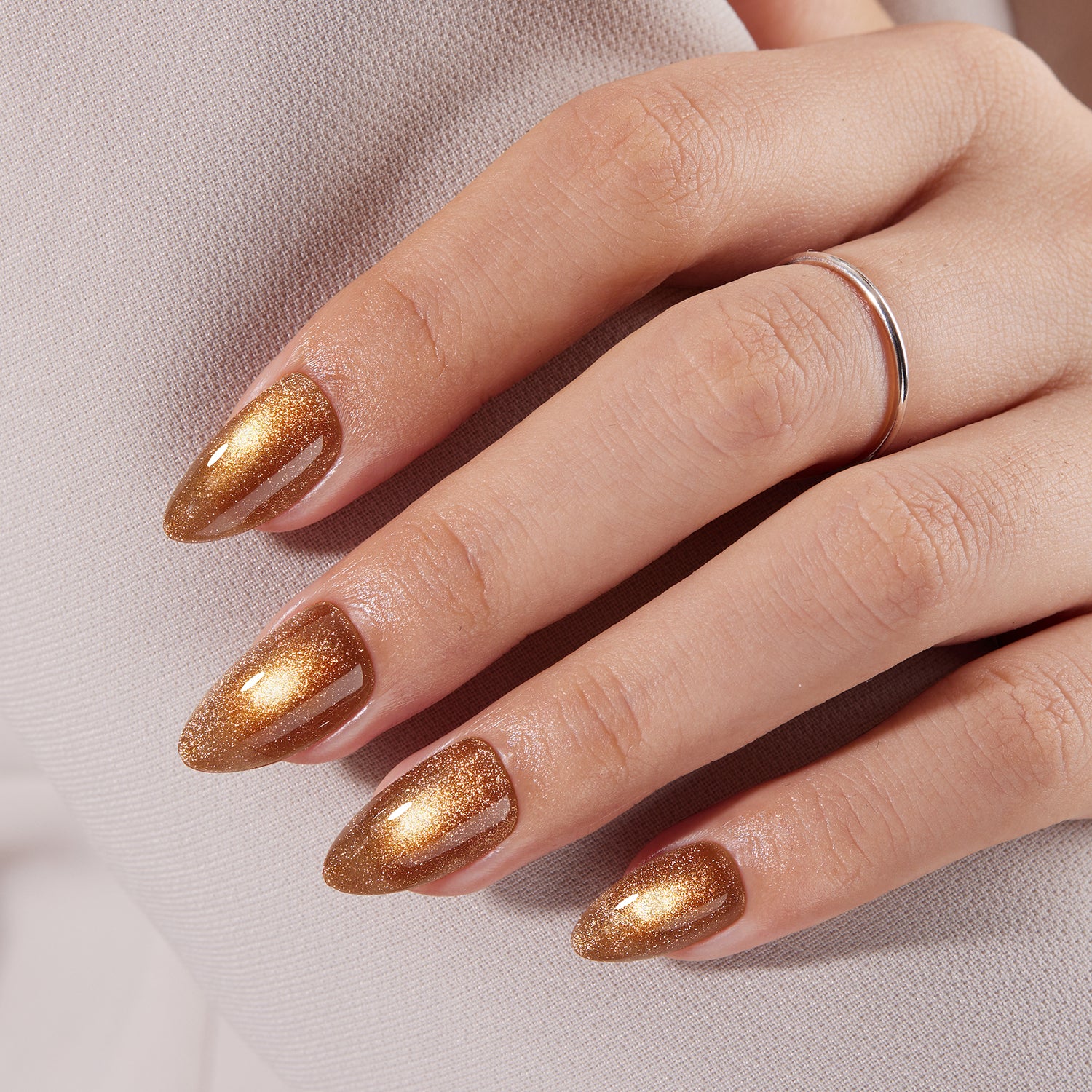 VSALON Nourishment Nails “Truffle Halo” Gold Short Almond Press On Nails – natural look on hand model.