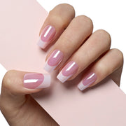 VSALON Nourishment Pink Bliss Pink French Tips Glossy Short Coffin Press On Nails - Close-up of model's hand bending fingers to hold VSALON press on nails – highlighting nail design and color details