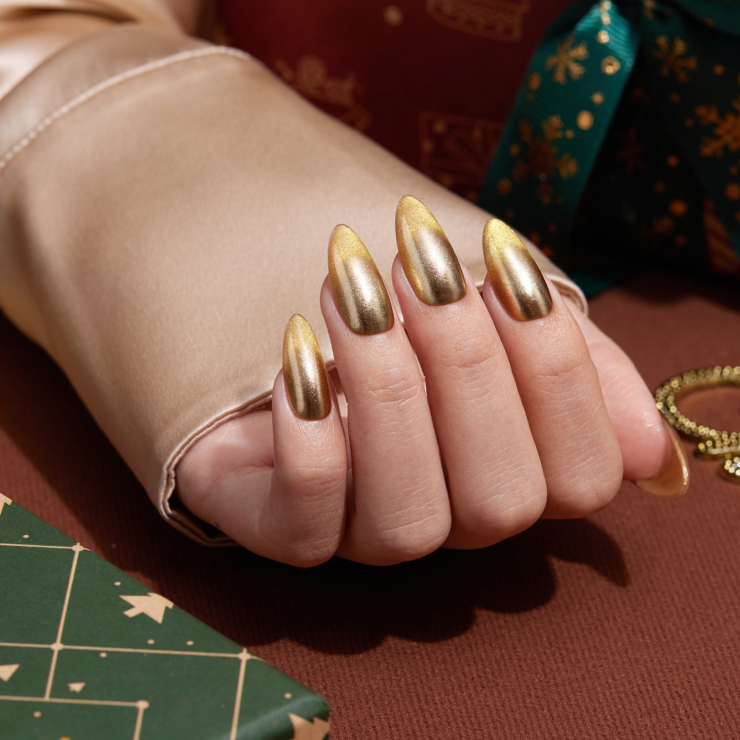 VSALON Nourishment Ra Gold Gold Metallic Cat-Eye Medium Almond Press On Nails - Close-up of VSALON punk press on nails with metallic studs and bold design