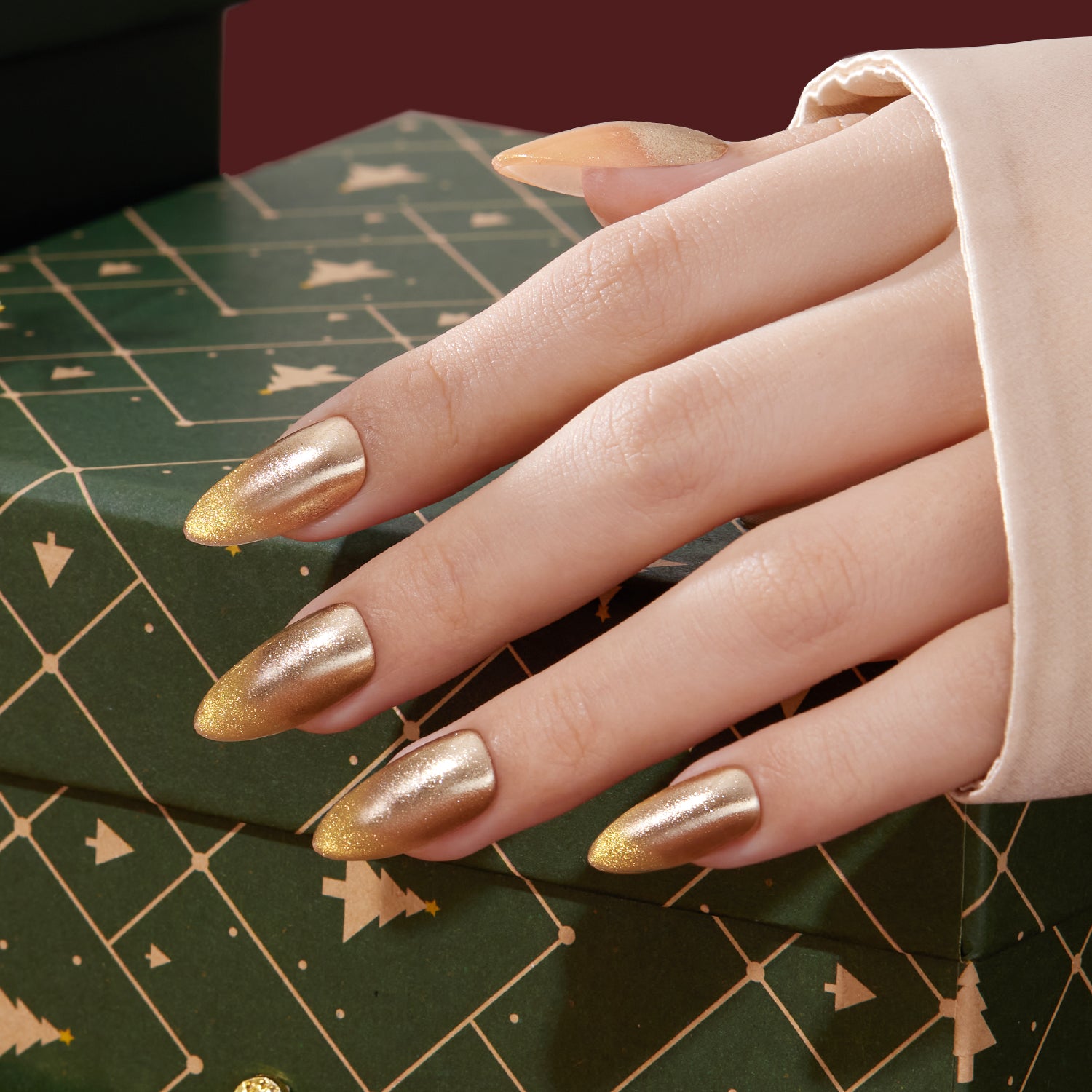 VSALON Nourishment Ra Gold Gold Metallic Cat-Eye Medium Almond Press On Nails - styled for a holiday party look.