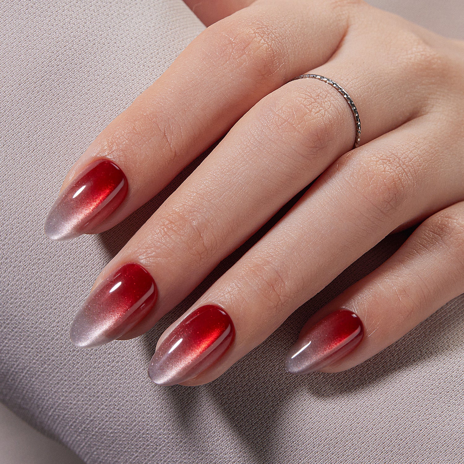 VSALON UV Cure Nails Scarlet Spell Red Cat Eye Short Almond Press On Nails - model's hand resting on elbow – showcasing nail style and elegant manicure
