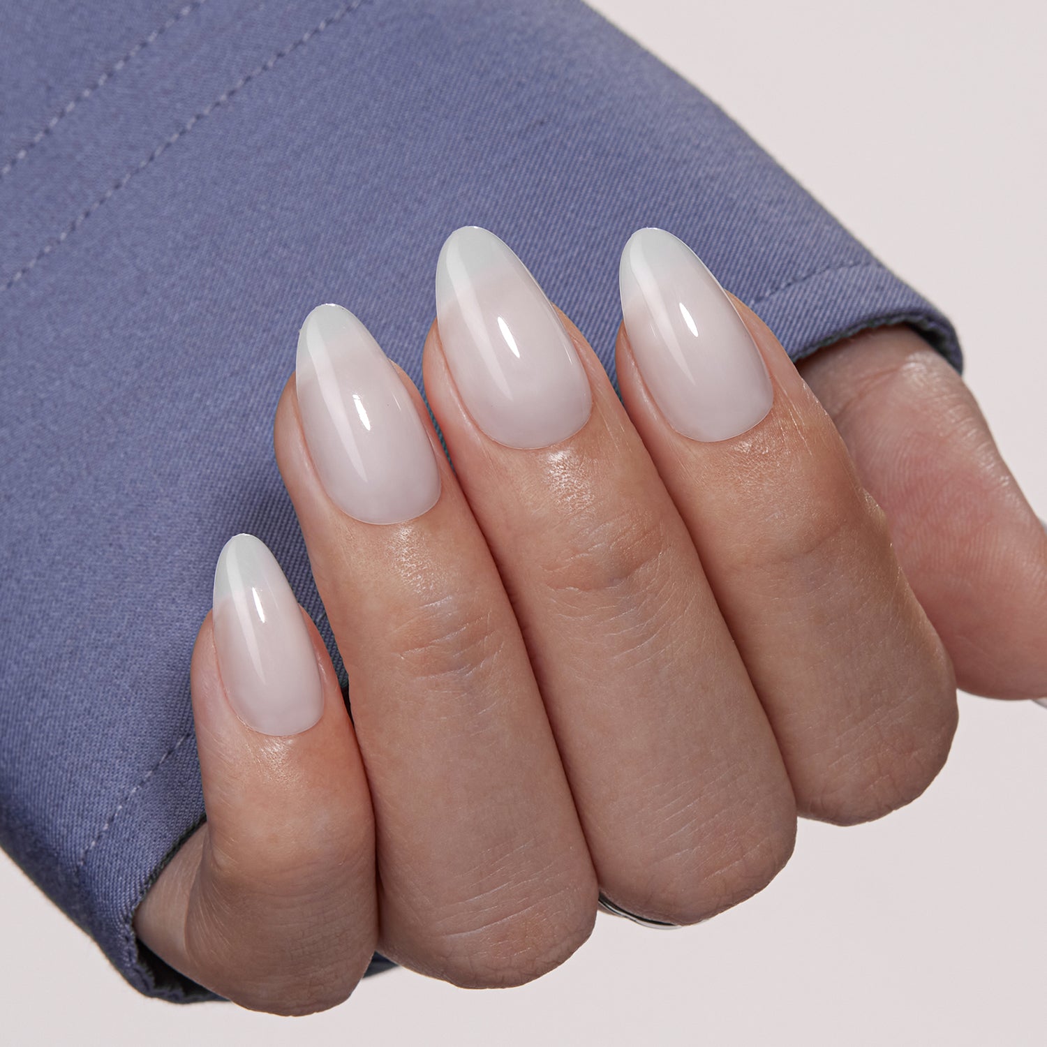 VSALON Dual Glam Nails Sky Cloud Blue Solid Color Short Almond Press On Nails - Close-up of model's hand bending fingers to hold VSALON press on nails – highlighting nail design and color details
