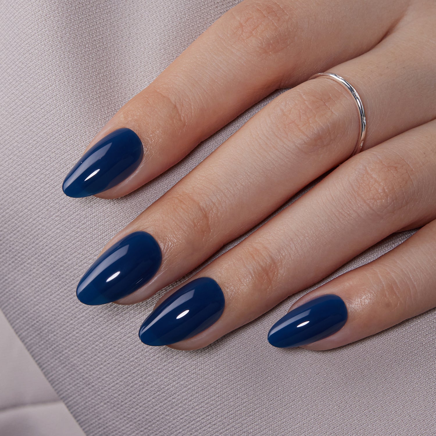 VSALON Dual Glam Nails Sky Cloud Blue Solid Color Short Almond Press On Nails - model's hand resting on elbow – showcasing nail style and elegant manicure