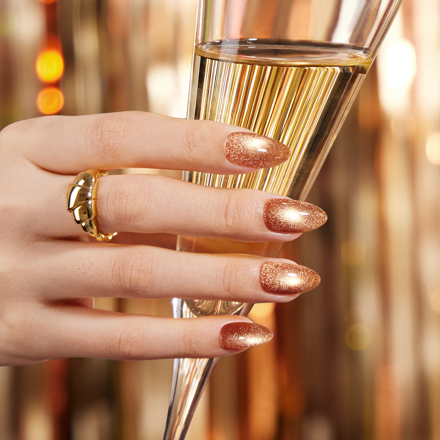 VSALON Nourishment “Truffle Halo”gold short almond press on nails styled for a holiday party look.
