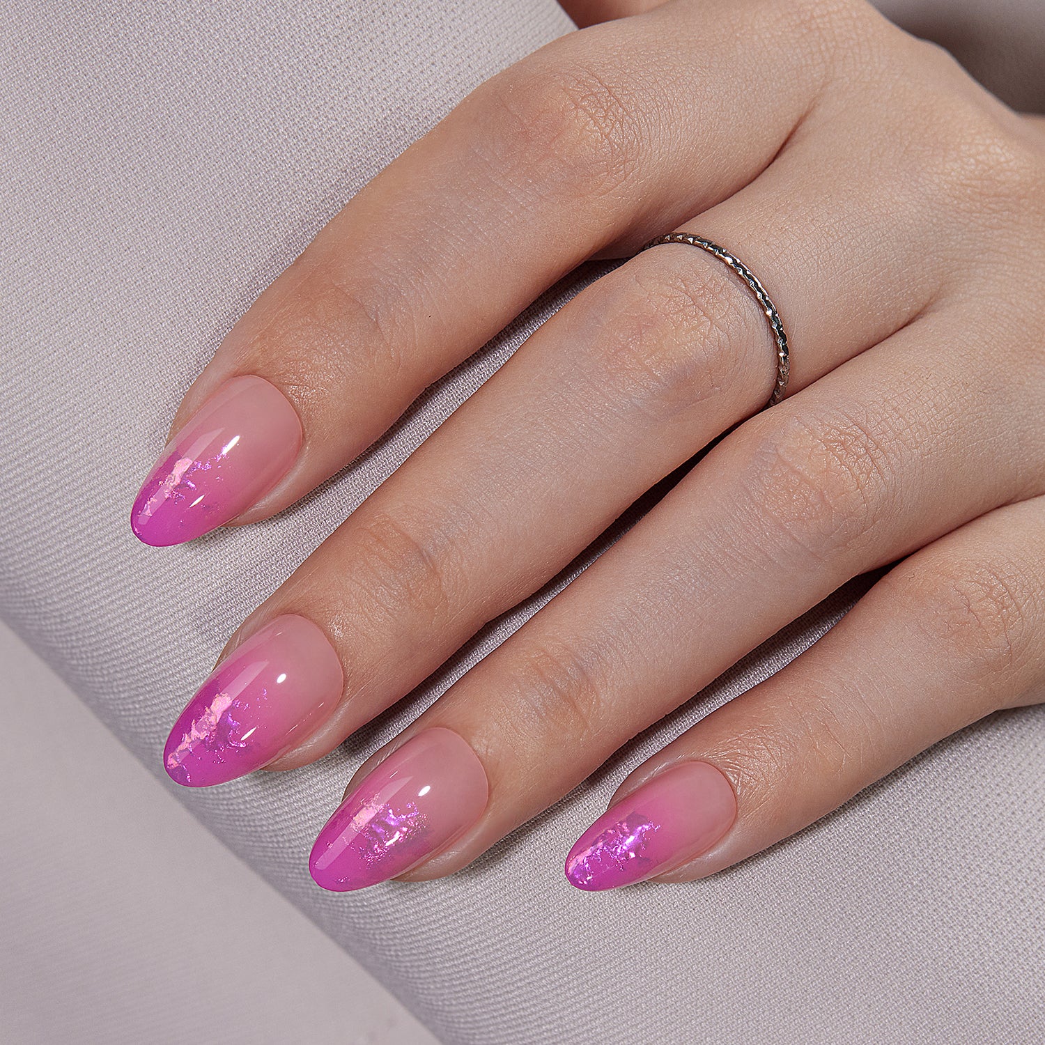 VSALON UV Cure Nails Unicorn Petal Gradient Flamingo Foil Pink Short Almond Press On Nails - model's hand resting on elbow – showcasing nail style and elegant manicure